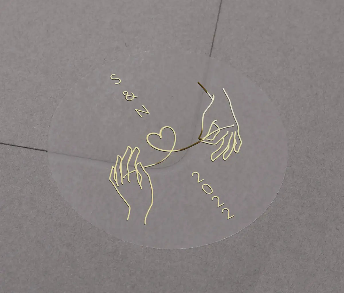 Wedding envelope sticker with personalised initials printed on clear sticker in gold foil