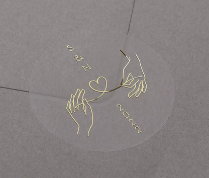 Wedding envelope sticker with personalised initials printed on clear sticker in gold foil