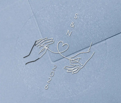 Wedding envelope seal with personalised initials printed on clear sticker in silver foil