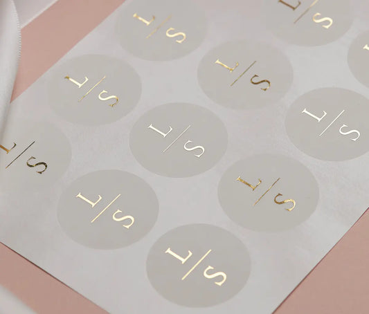 Personalized initials printed in gold foil on round clear sticker sheet
