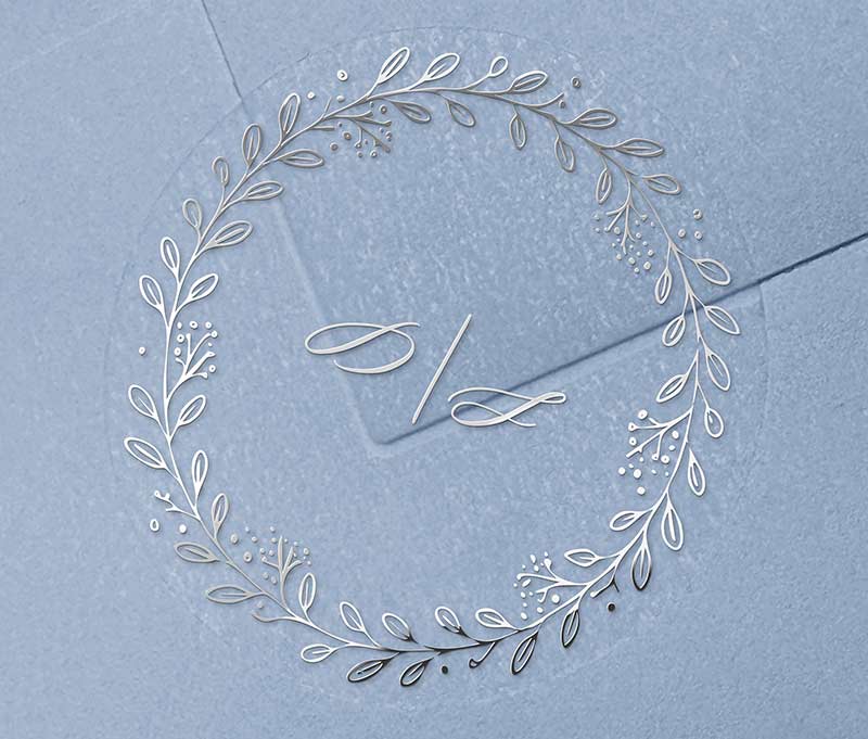 Wedding envelope seal with wreath graphic and silver printed personalized initials.