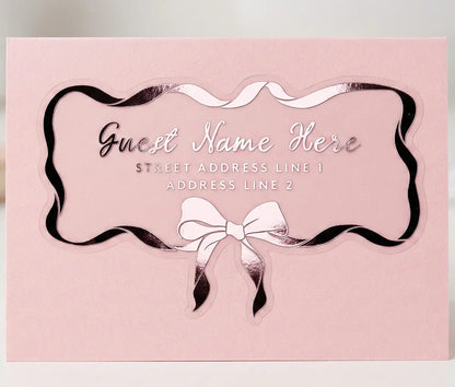Guest address label applied to a pink colour envelope with custom die cut bow and ribbon shape