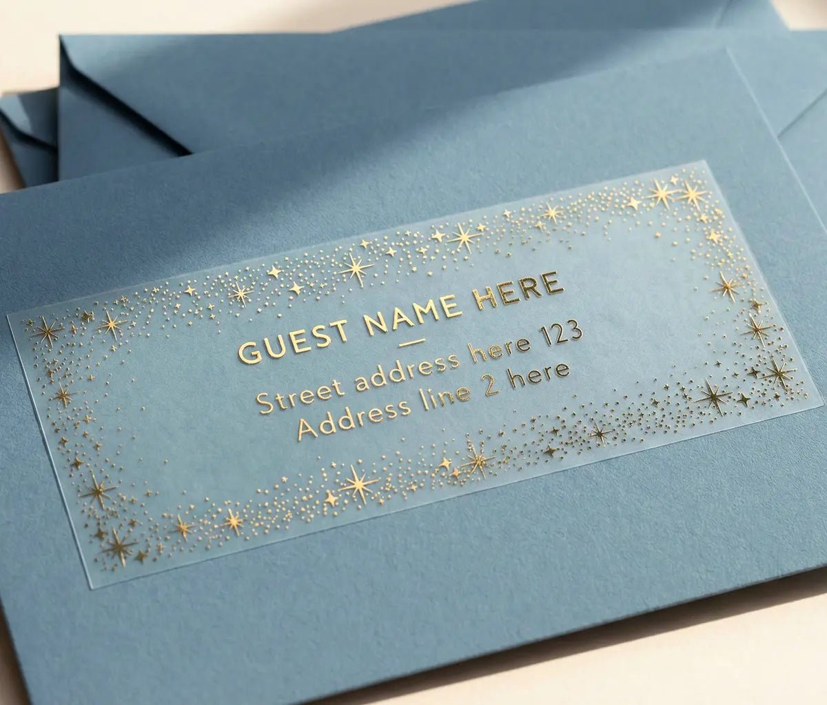 Address label with gold text and star design on a blue envelope