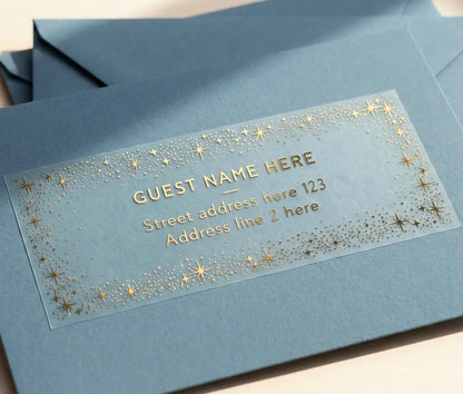 Address label with gold text and star design on a blue envelope