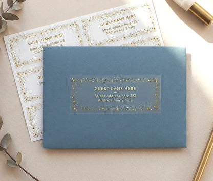Guest address label with celestial theme frame printed in gold foil on transparent label and applied to a slate blue envelope.