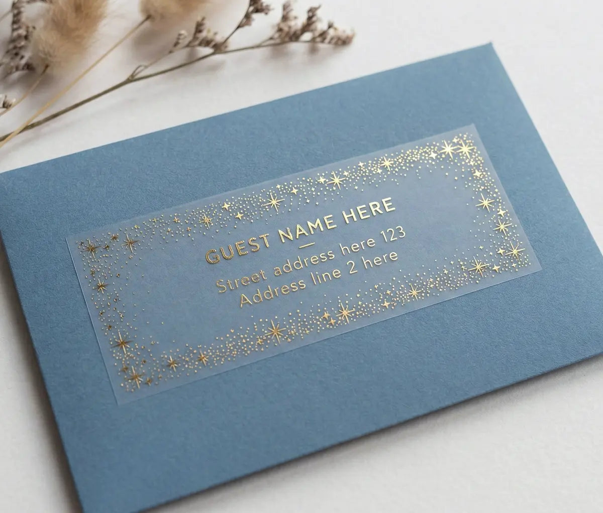 Blue envelope with a clear label for wedding guest address and celestial starry frame printed in gold foil