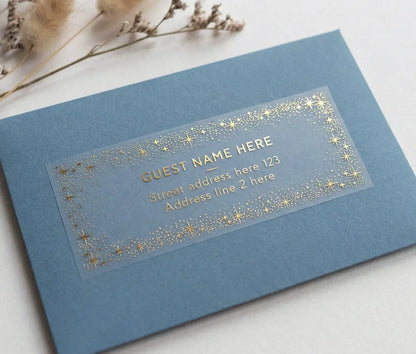 Blue envelope with a clear label for wedding guest address and celestial starry frame printed in gold foil
