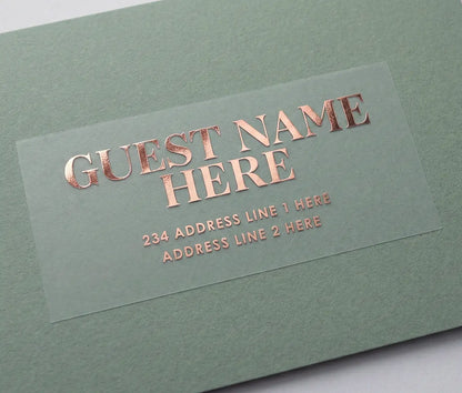 Custom Guest address sticker featuring bold serif font printed in rose gold foil on transparent matte vinyl and applied to a sage green envelope.