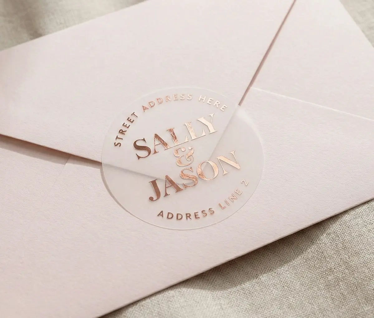 Light Pink envelope with round Retun Address Label printed in rose gold foil on transparent matte vinyl.