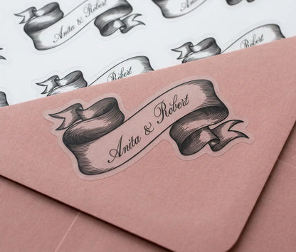 Pink envelope with ribbon design sticker and personalized names.