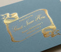Gold guest address label on a blue envelope with bespoke vintage-style scroll design
