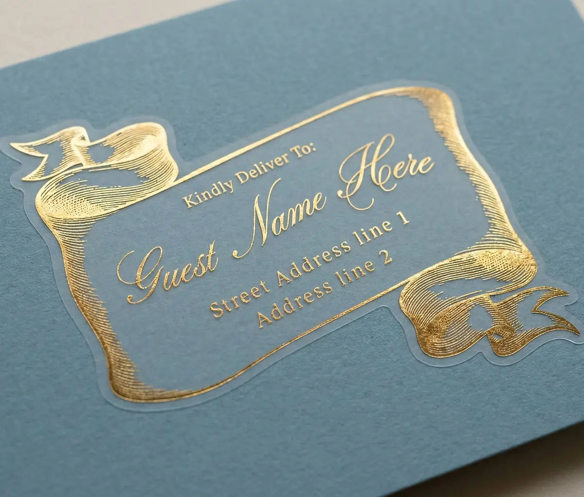 Gold guest address label on a blue envelope with bespoke vintage-style scroll design