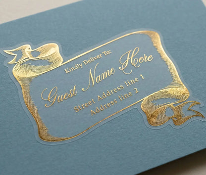 Gold guest address label on a blue envelope with bespoke vintage-style scroll design