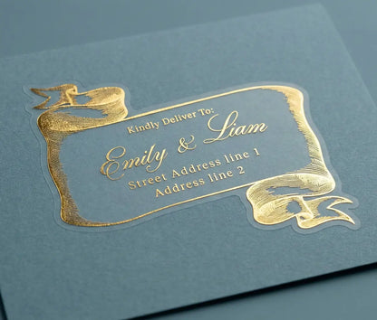 Custom Gold guest address label on a blue envelope with bespoke whimsical scroll design.