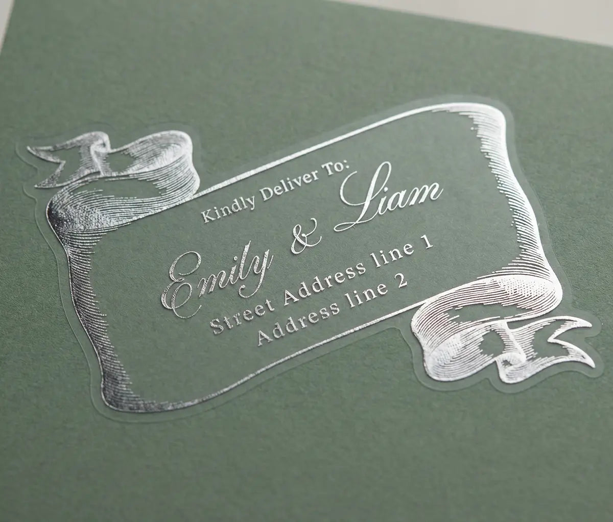 Clear guest address label with silver foil printed text on a green envelope.